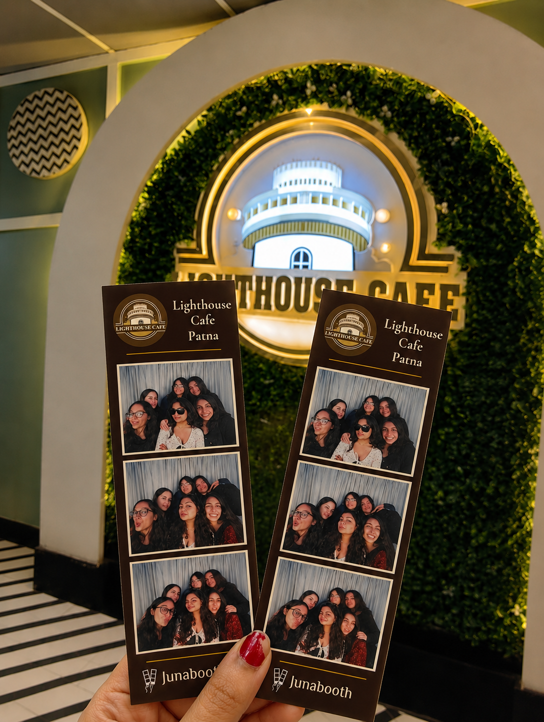 Guests holding Lighthouse Cafe photo strip
